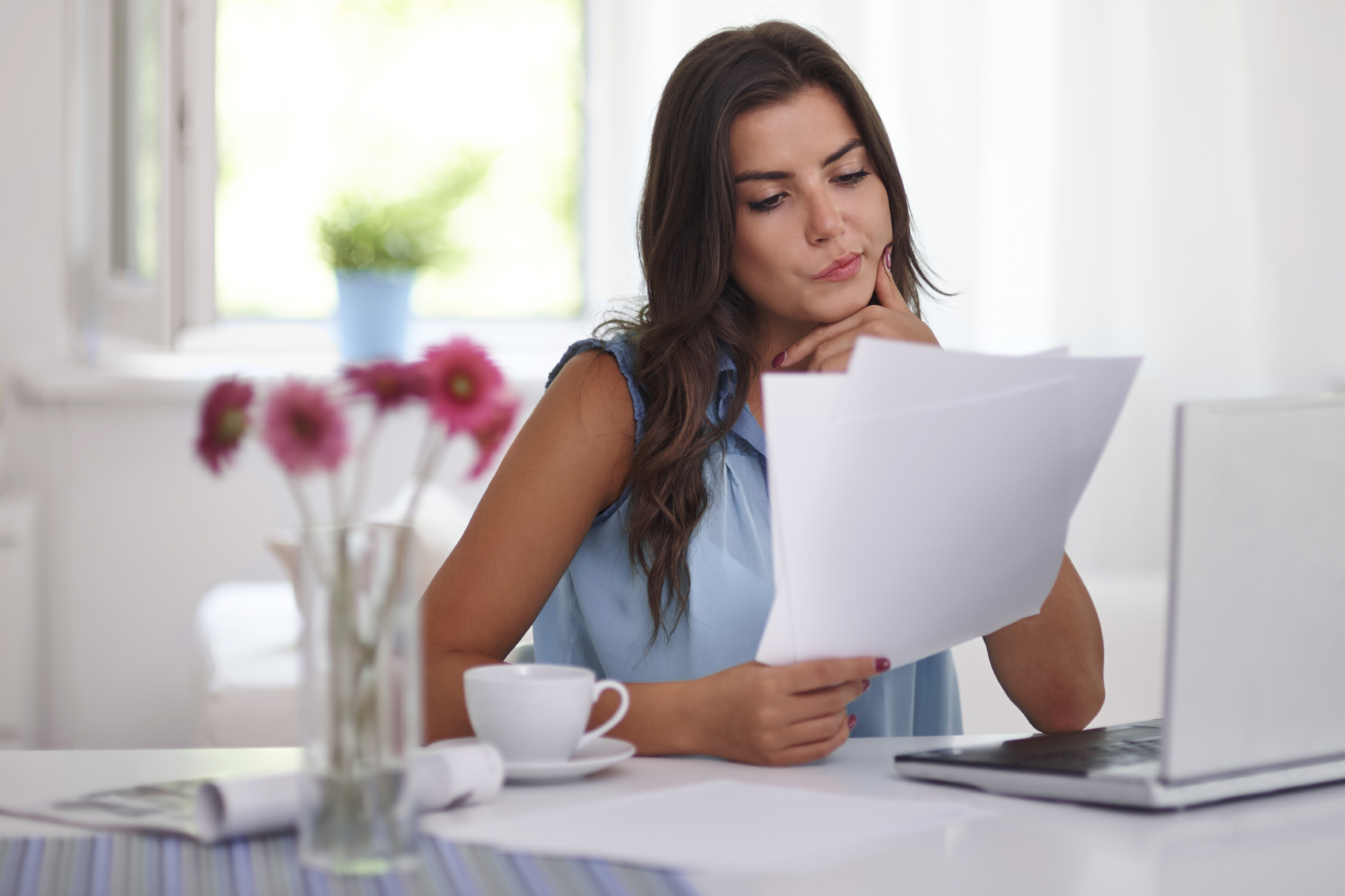 Woman at desk looking at paper