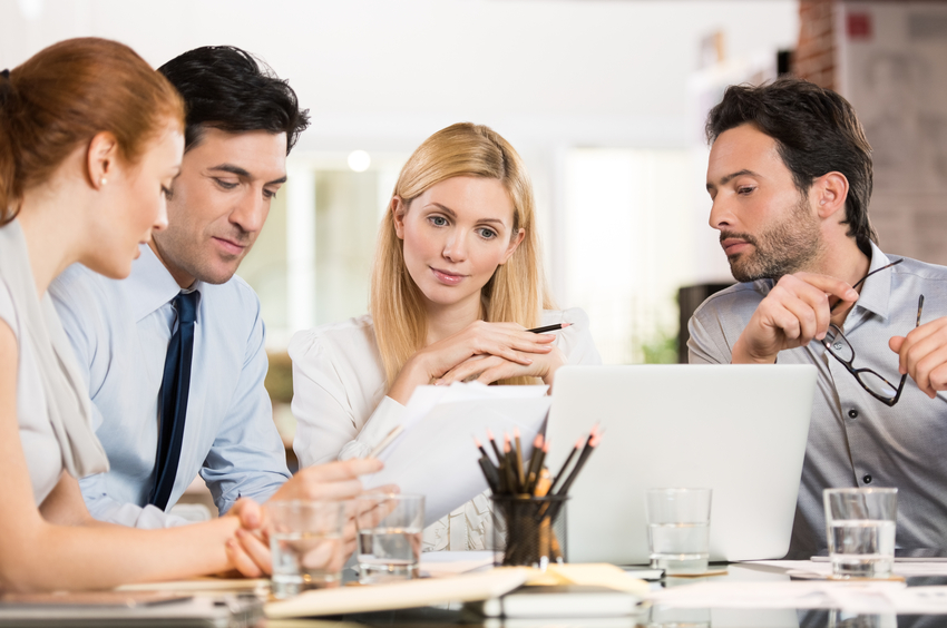 Manager with his colleague discuss about the business plan. Business team working at office. Business meeting in a conference room analyzing corporate reports.