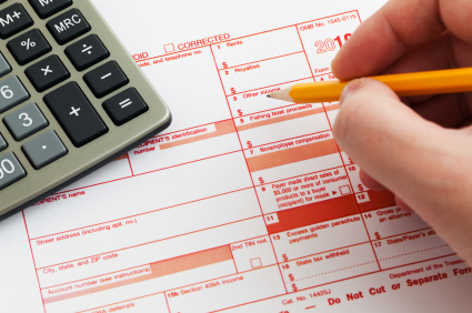 Form 1099-MISC for 2010 with calculator and pencil on it